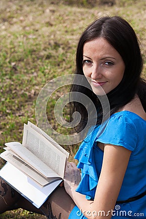 Girl reading book in spring park