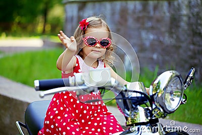 Girl in a red dress on a motorcycle