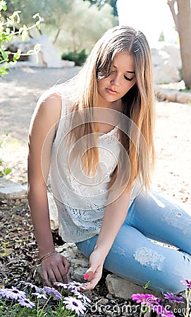 Girl sat down near flower