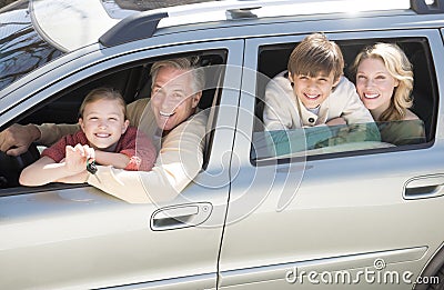 Girl Showing Car Keys While Sitting With Family In Car