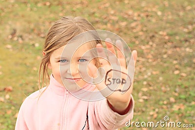 Girl with sign STOP on hand