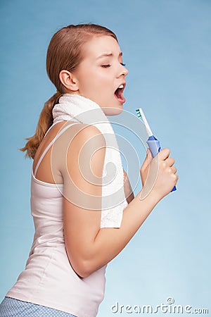 Girl singing to toothbrush. Dental teeth care.