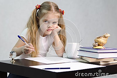 The girl writes on a piece of paper sitting at the table in the image of the writer