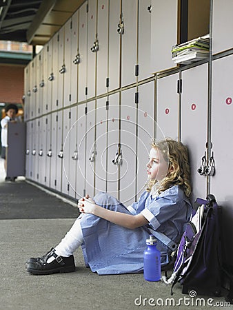 Girl Sitting Against School Lockers