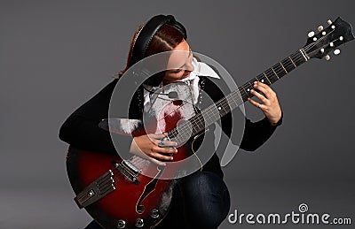 Girl sitting with bass guitar and play music