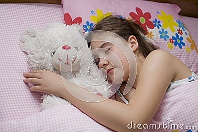 Girl sleeping with teddy bear