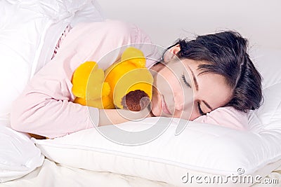 Girl sleeping with teddy bear