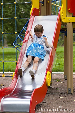 Girl sliding on playground