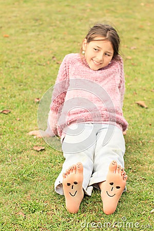 Girl with smileys on toes and soles