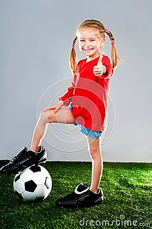 Girl with soccer ball in boots