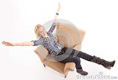 Girl stretching arms and legs on an armchair