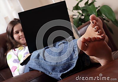 Girl surfing the internet with feet up