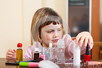 Girl at table with cosmetic products