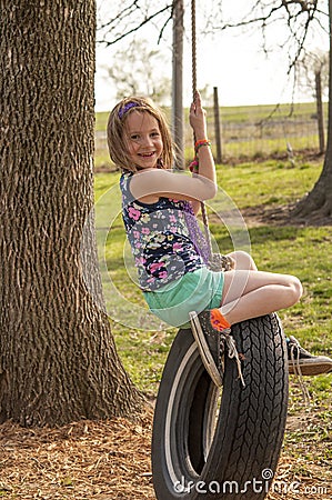 Girl on tire swing