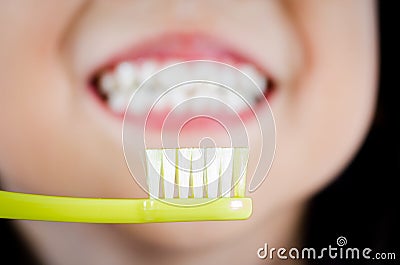 Girl with toothbrush cleaning teeth