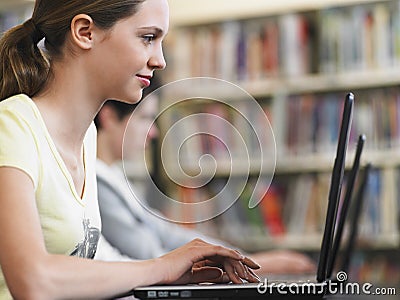 Girl Using Laptop In Library