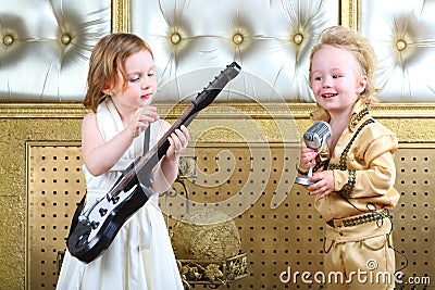 Girl in white dress plays guitar and pop musician sings