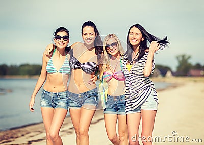 Girls in bikinis walking on the beach