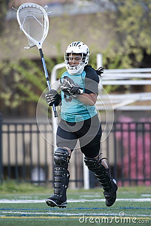 Girls lacrosse goalie taking the field