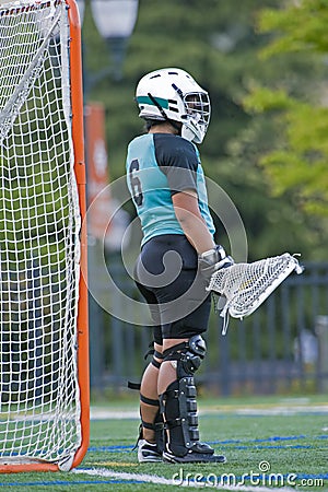 Girls lacrosse goalie waiting for action