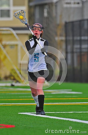 Girls Lacrosse player passing the ball