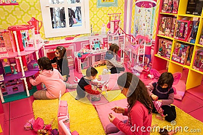 Girls playing inside Barbie s house at G! come giocare in Milan, Italy