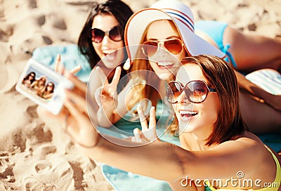 Girls taking self photo on the beach