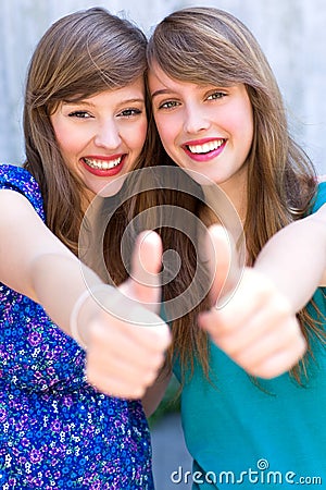Girls with thumbs up