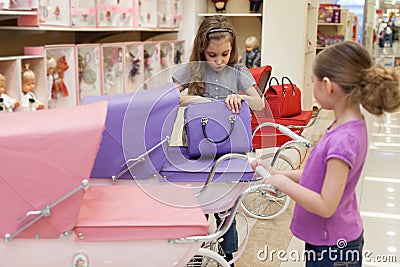 Girls in a toy store purchased a buggy and handbag