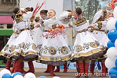 Girls in traditional costumes dancing on stage