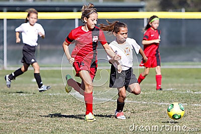 Girls Youth Soccer Football Players Running for the Ball