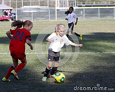 Girls Youth Soccer Football Players Running for the Ball