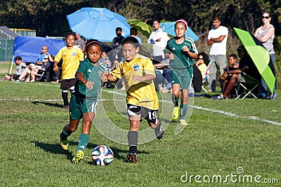 Girls Youth Soccer Football Players Running for the Ball