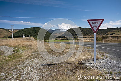 Give way sign on rural road in New Zealand