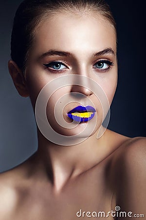 Glamor closeup portrait of beautiful sexy stylish young woman model with bright makeup, with creative colorful bright blue yellow