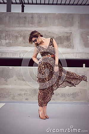 Glamorous woman in animal print outfit fluid dress