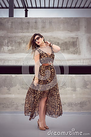 Glamorous woman in animal print outfit maxi dress