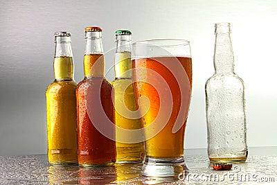 Glass of beer with bottles