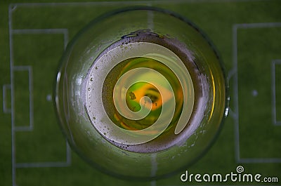 Glass of beer and soccer field