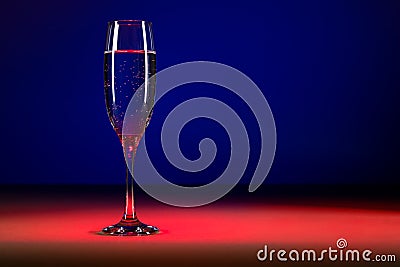 Glass of champagne on colorful background. Studio shot of Glass of bubbly
