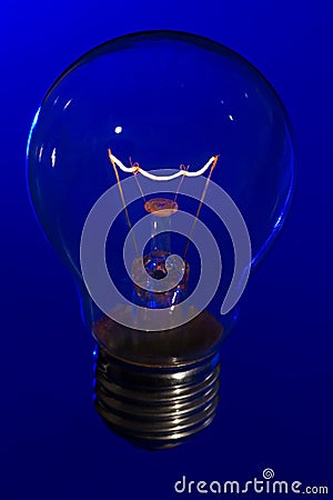 Glass light bulb with burning filament upright