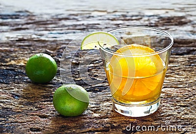 Glass of tea with lemon on wooden background, infusion tea and colorful