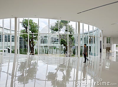 Glass wall in the building with people walking