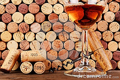 Glass of Wine in Front of a Wall of Used Corks