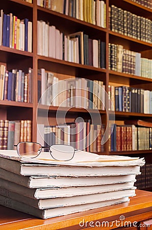 Glasses and books on library table