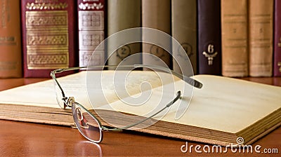 Glasses in front of an old books