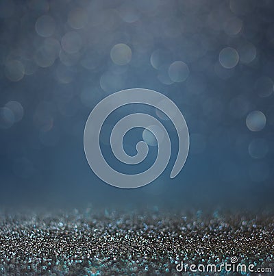 Glitter vintage lights background with light burst . silver, blue and white. de-focused.