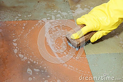 Gloved hand cleaning of dirty filthy floor