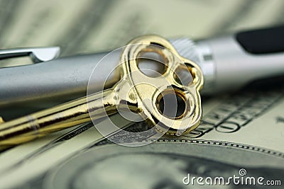 Gold key with pen and money