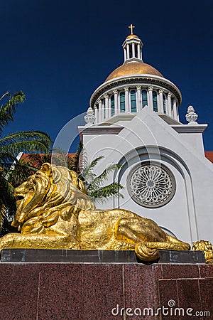 Gold lion statue in front of church